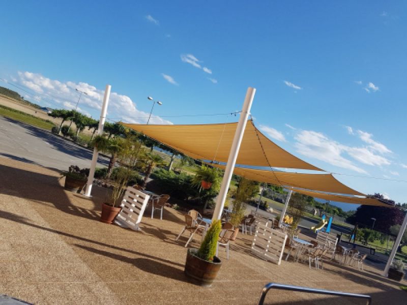 Terraza de bar exterior con toldo